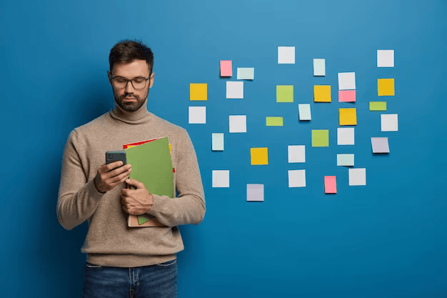 bearded male organizing his tasks using sticky notes 273609 37353